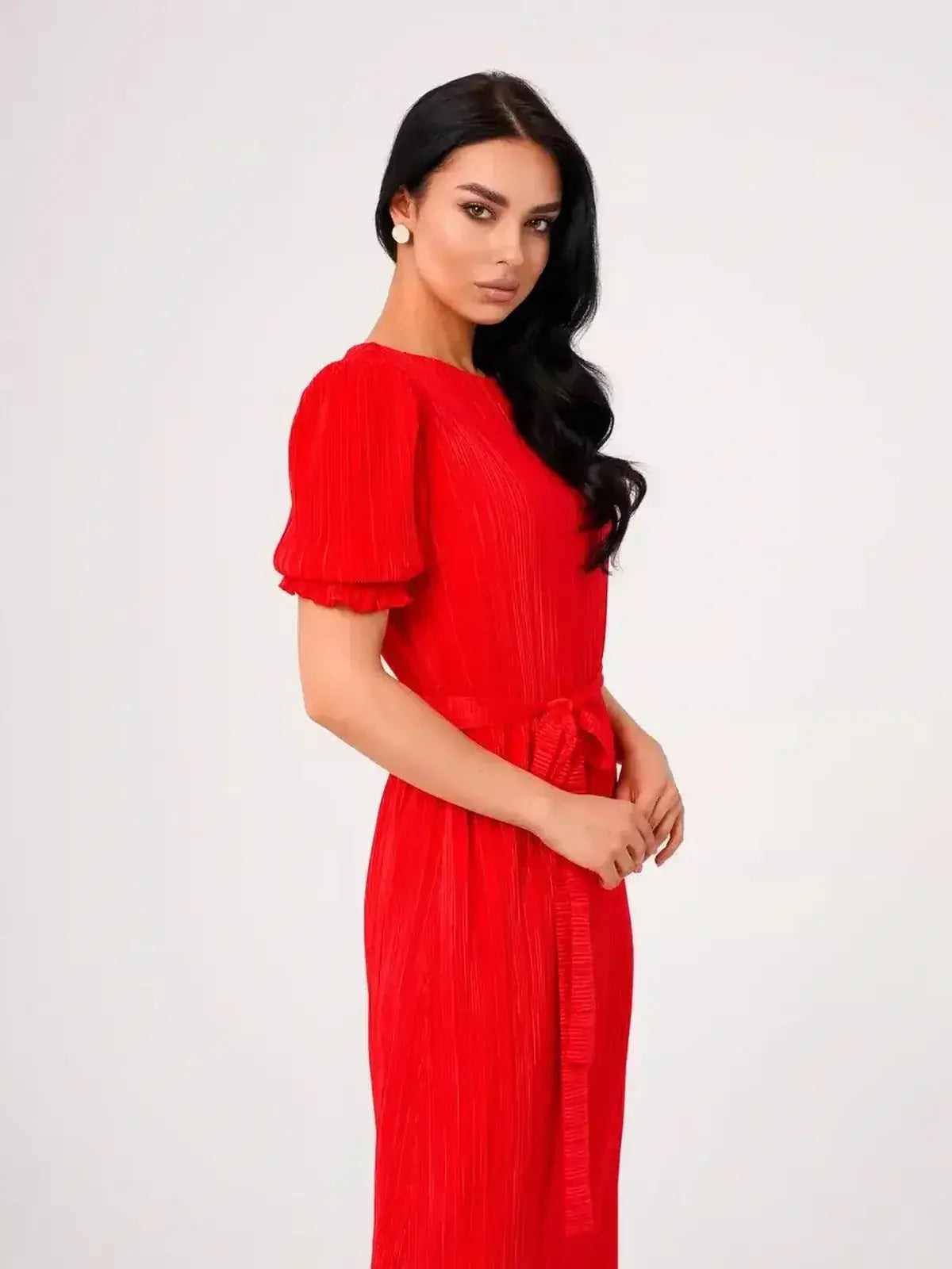 Model showcasing the Ophelia Maxi Dress by Lauven, featuring pleated elegance and a belted waist in vibrant red.