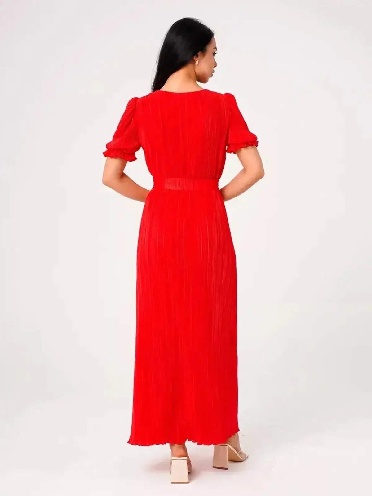 Back view of a model wearing the Ophelia Maxi Dress in vibrant red with pleats and puff sleeves.