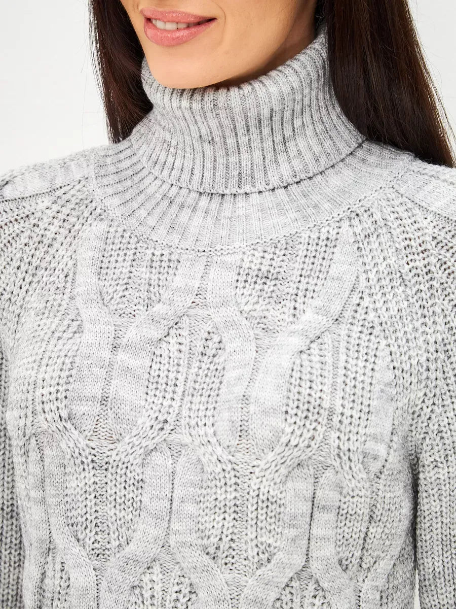 Close-up of a woman wearing the Osiris Sweater by Lauven, showcasing the oversized cable knit design and high turtleneck.