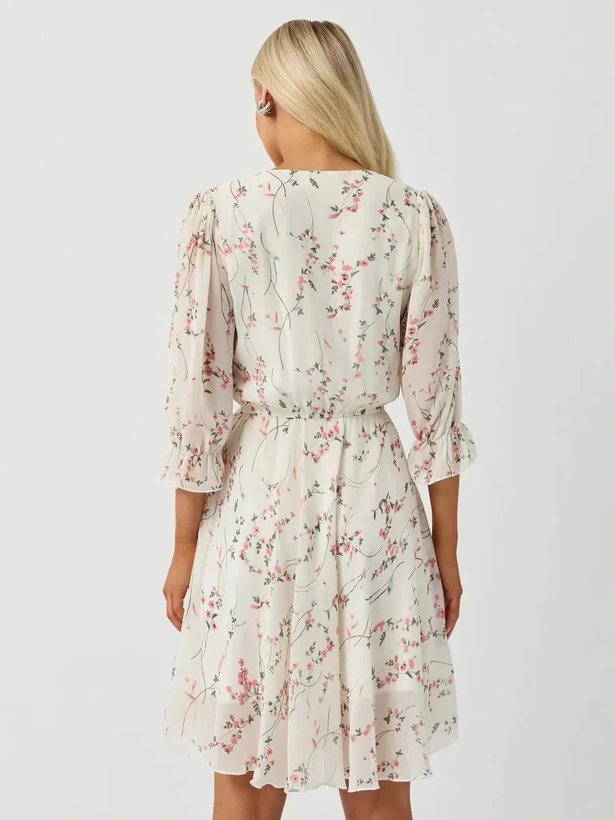 Back view of the Lauven Petunia Mini Dress showcasing its floral print and three-quarter sleeves.
