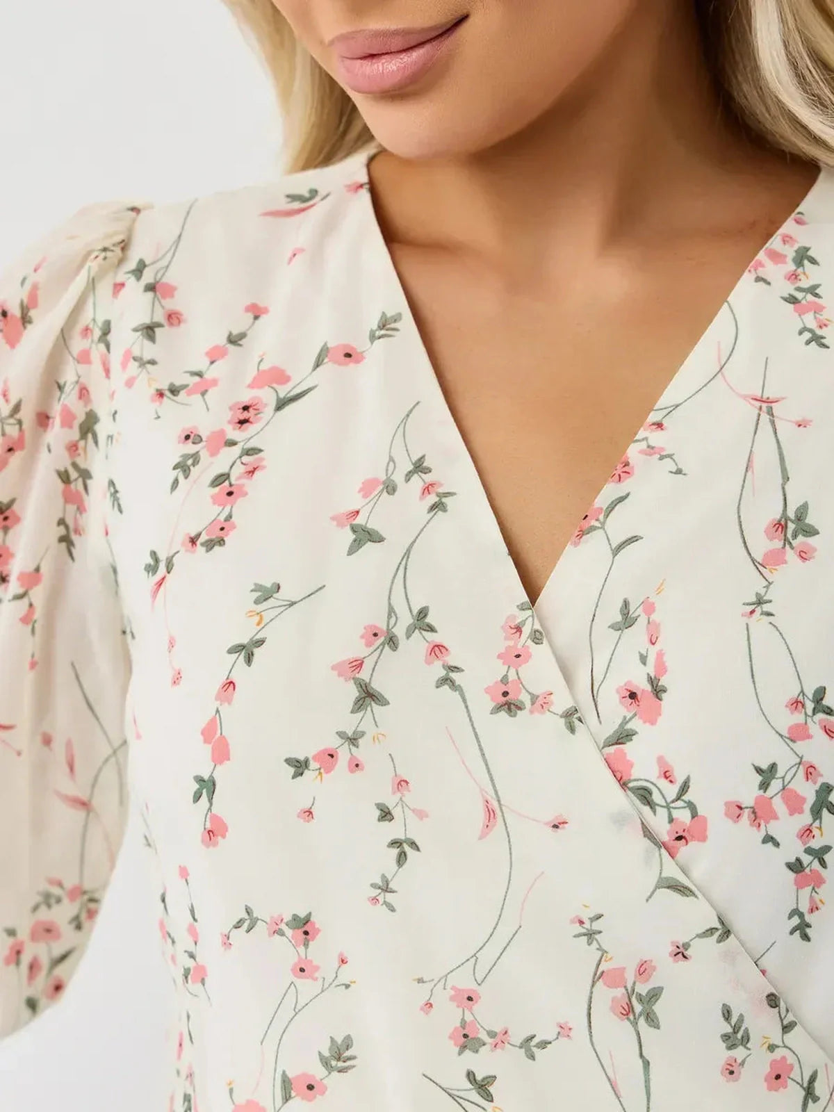 Close-up of the Petunia Mini Dress by Lauven, featuring a white floral pattern and a V-neckline.