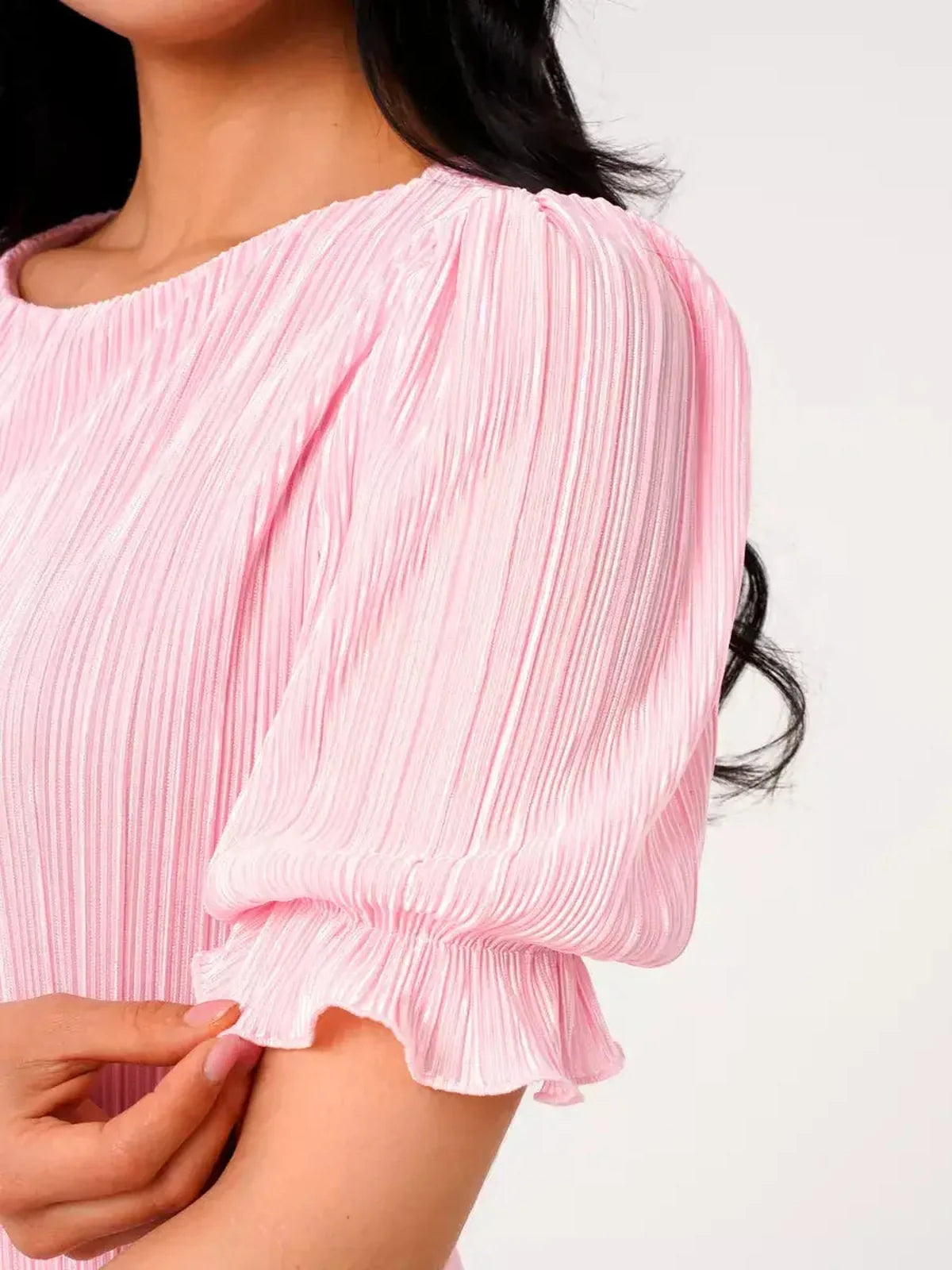 Close-up of Candy Maxi Dress by Lauven, featuring pleated pink fabric and elegant puff sleeves.