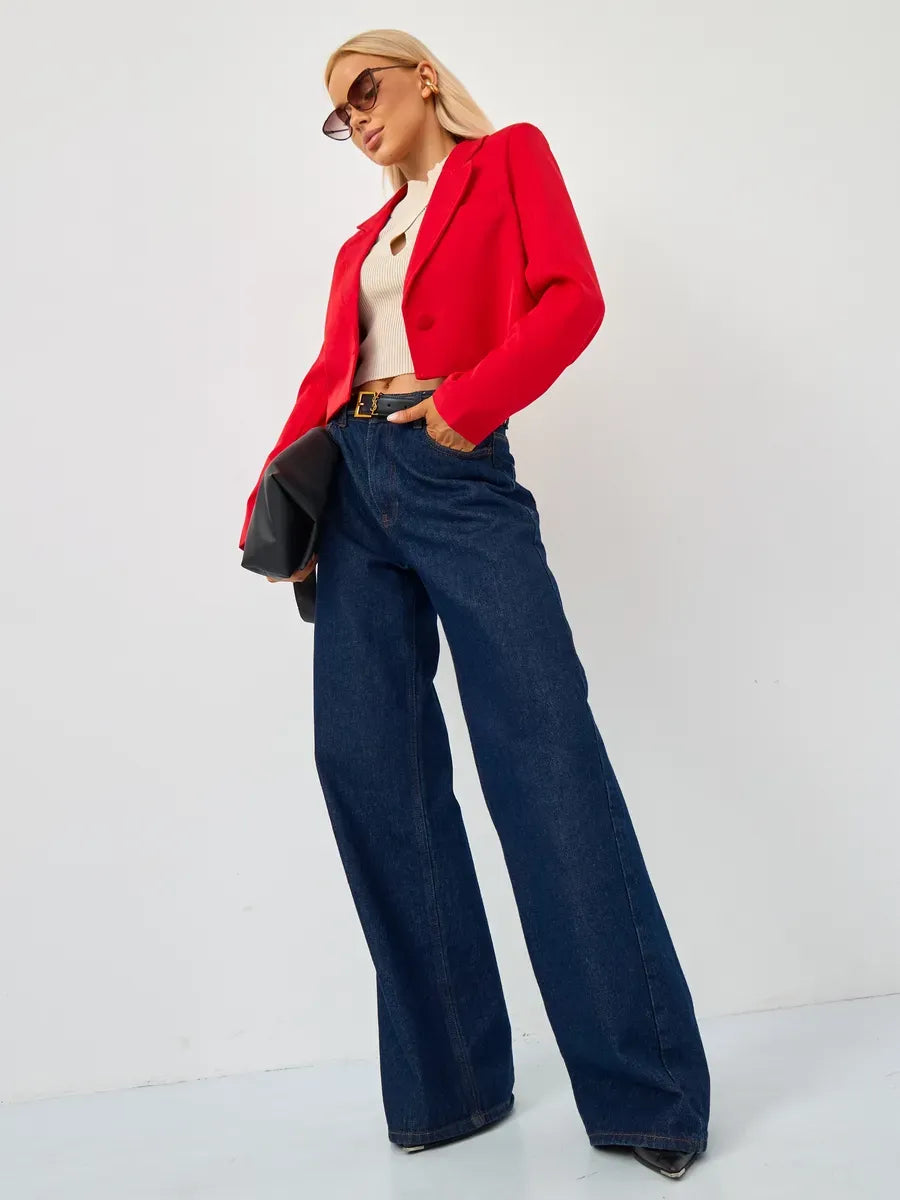 Ruby Blazer by Lauven, a cropped tailored red jacket styled with wide-leg jeans and chic accessories.