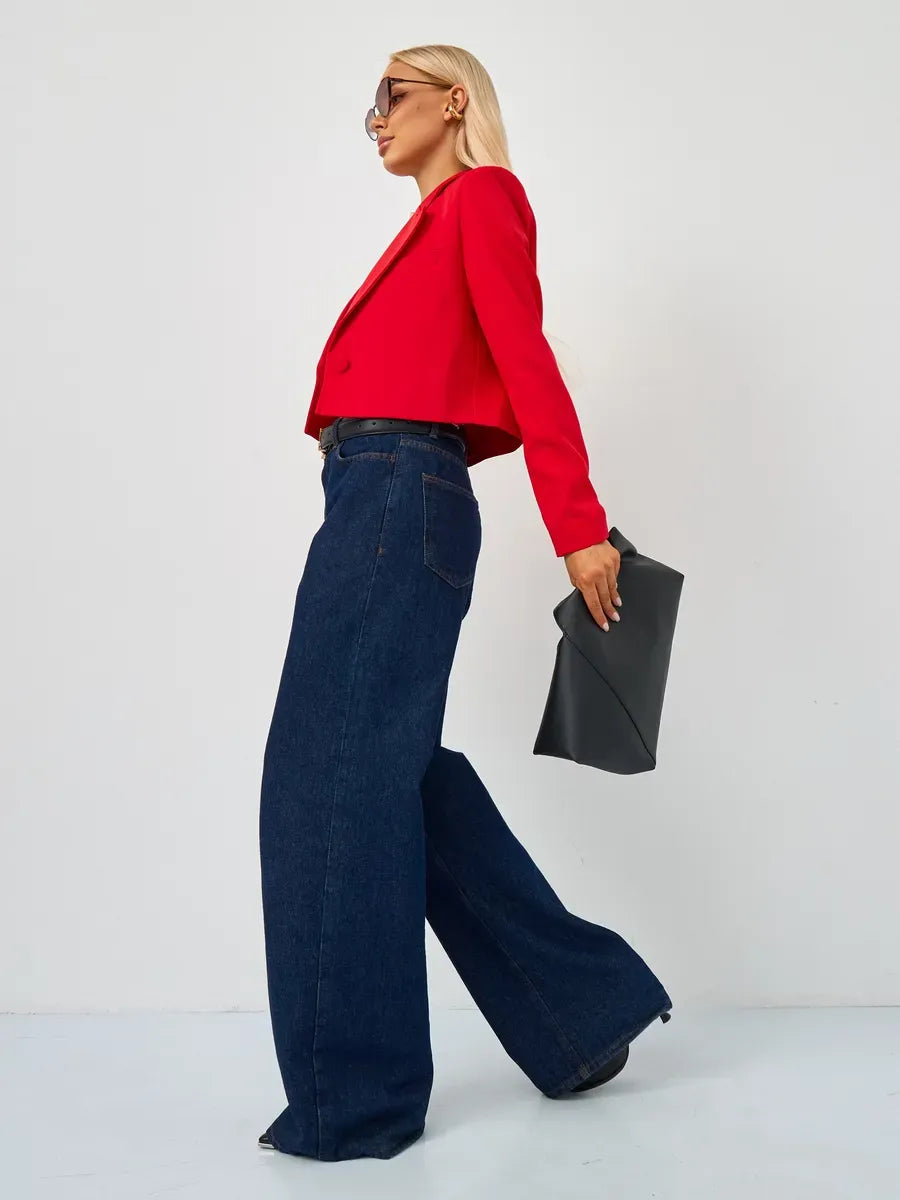 Ruby Blazer by Lauven worn with wide-leg jeans, showcasing a cropped tailored design in striking red.
