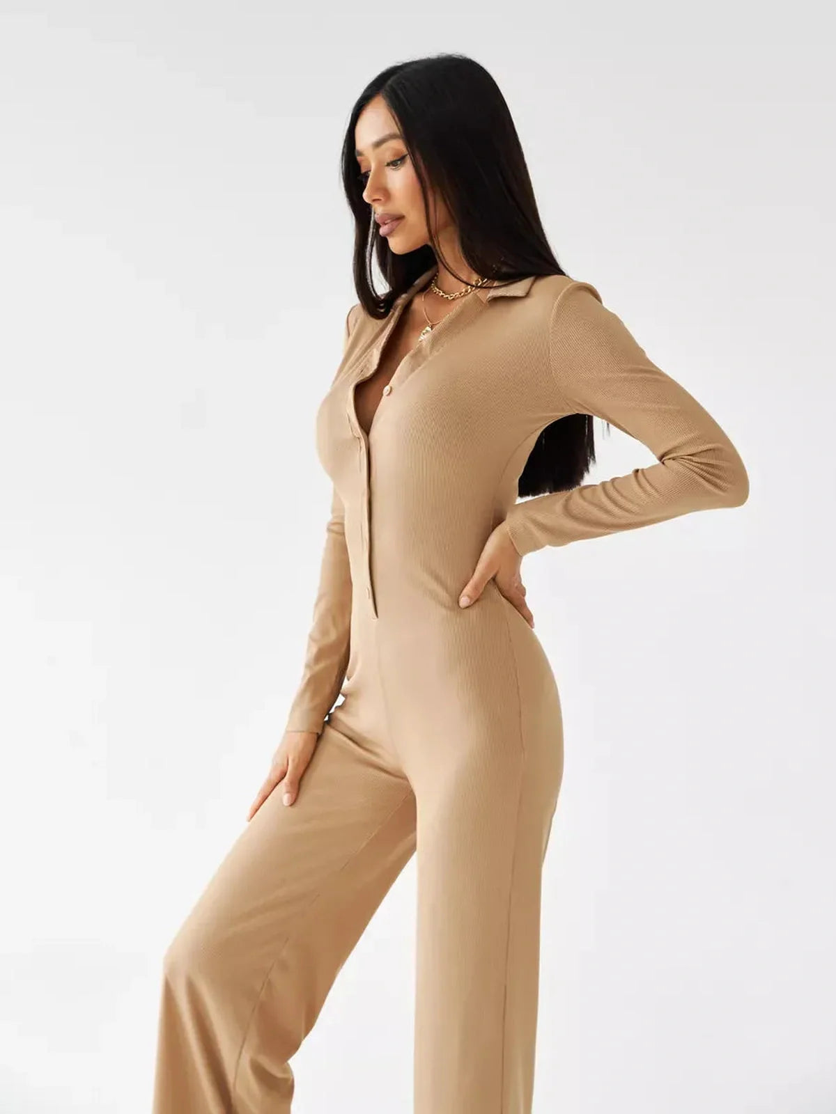 Jersey Jumpsuit in sand ribbed knit with button-front, tailored collar, and wide-leg silhouette.