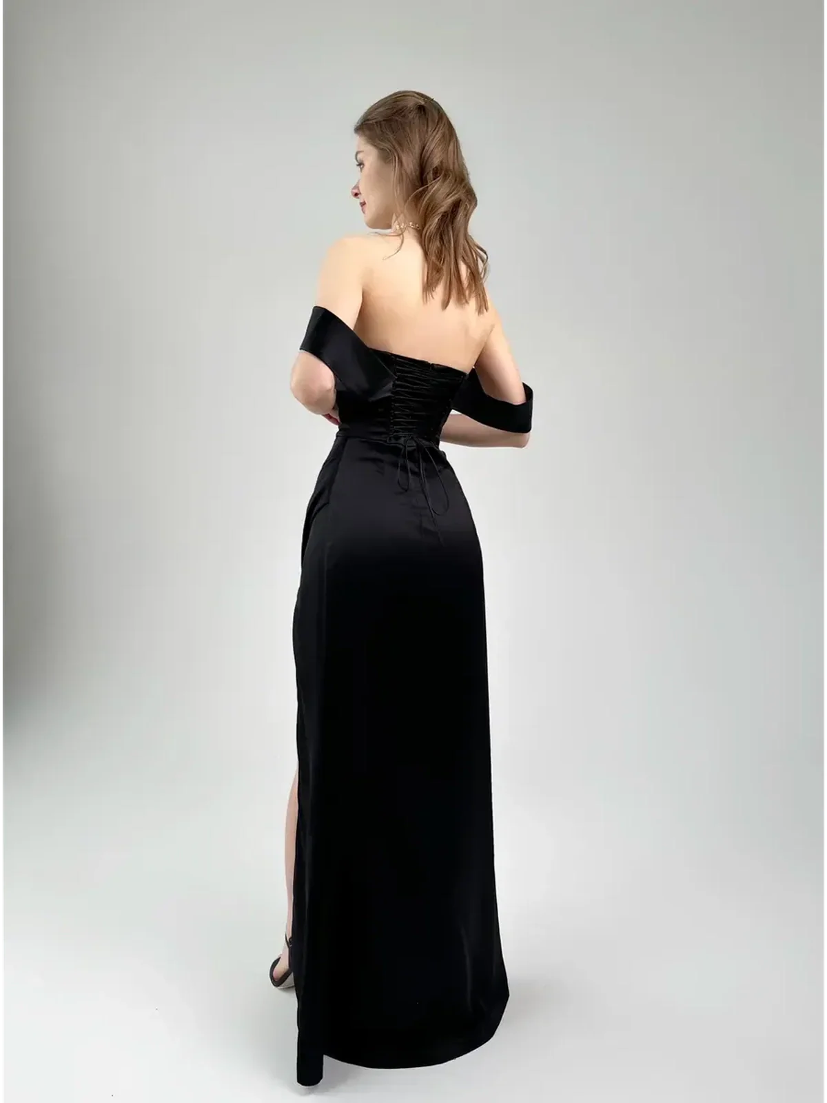 Selene Party Dress by Lauven, elegant off-shoulder satin gown with high slit, showcased from the back.