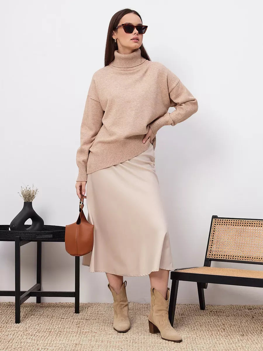 Selene Sweater in dark beige by Lauven, styled with a chic skirt and boots for a modern look.