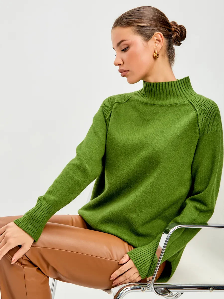 Siena Sweater by Lauven, oversized cashmere blend sweater with high neck in green worn by model.