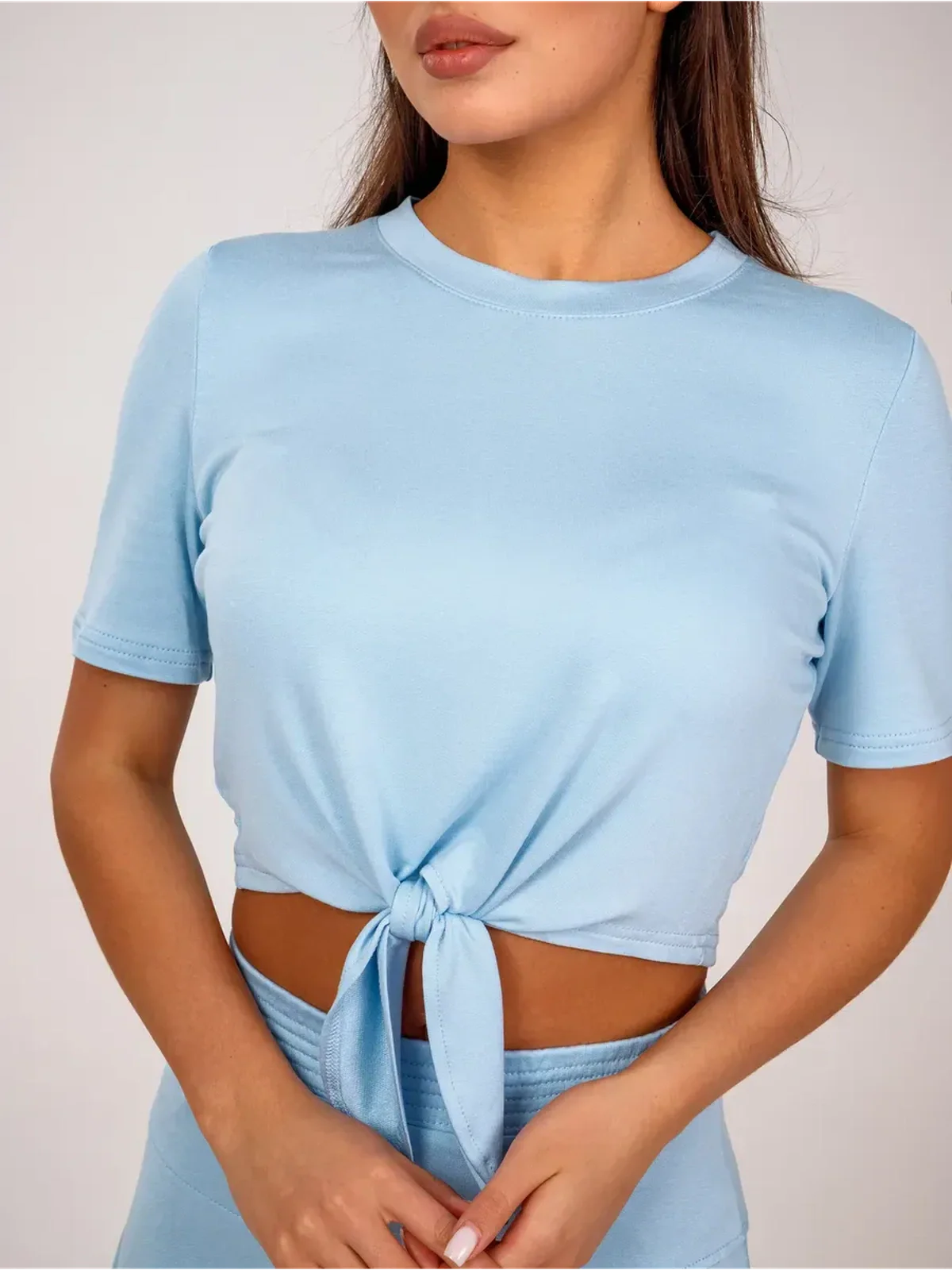 Vivienne Set by Lauven – Ice blue cropped top with adjustable front tie, part of the two-piece set.