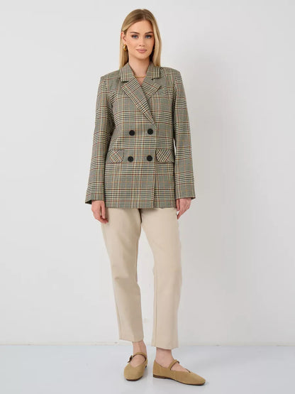 Model wearing a Maple Blazer by Lauven, an elegant oversized brown checked women's blazer.
