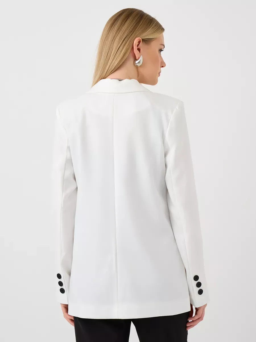 Back view of a woman wearing the Lauven Alabaster Blazer, an oversized white tailored jacket.