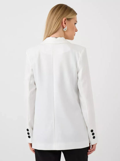 Back view of a woman wearing the Lauven Alabaster Blazer, an oversized white tailored jacket.