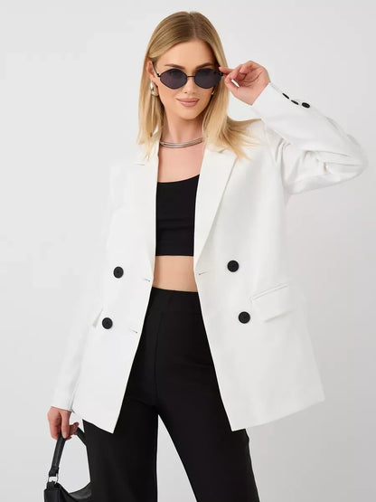 Model wearing Alabaster Blazer by Lauven, an oversized double-breasted white tailored jacket with chic styling.