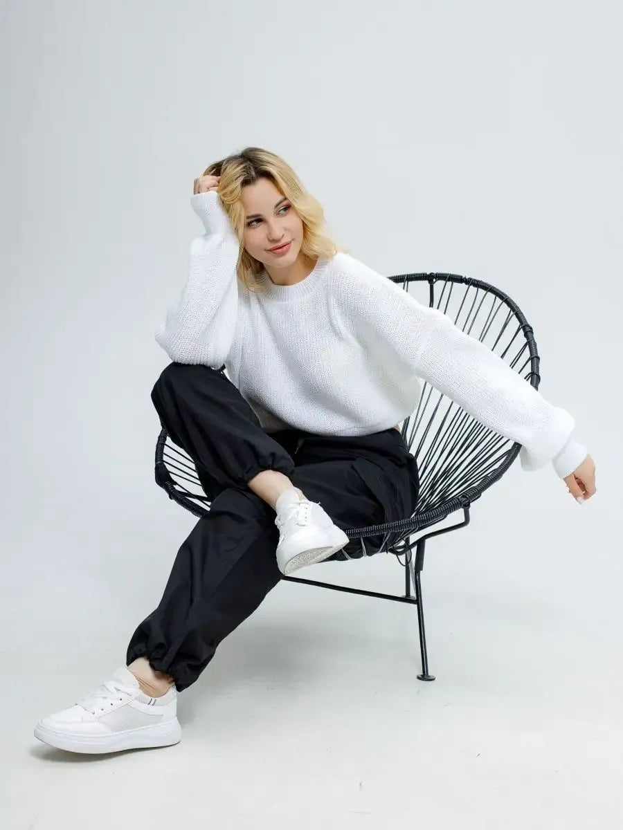 Alba Pullover by Lauven - Lightweight knit in soft white, styled with relaxed black joggers.