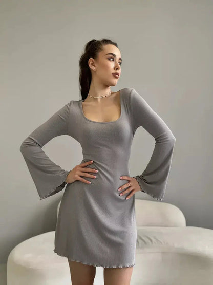 Amelia Mini Dress by Lauven in gray ribbed knit with long bell sleeves and tie-back detail.