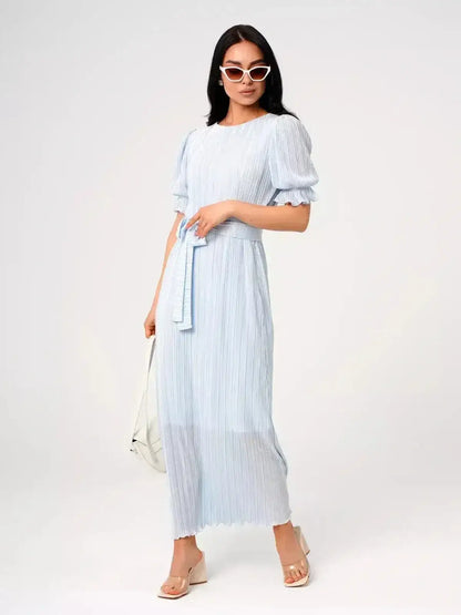 Angel Maxi Dress in light blue with pleats and waist tie, exuding elegance and sophistication for warm-weather occasions.