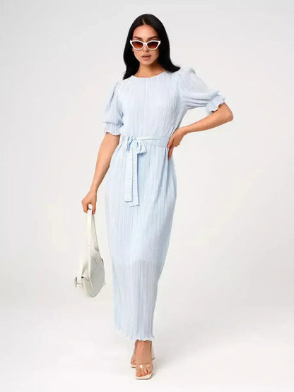 Angel Maxi Dress – Light blue pleated elegance with a waist tie and puff sleeves, perfect for warm weather.