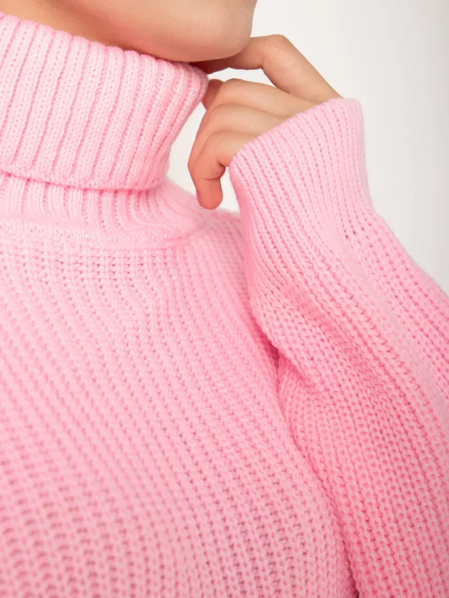 Close-up of the high neck of the Blossom Pullover by Lauven in soft light pink knit, showcasing cozy oversized design.