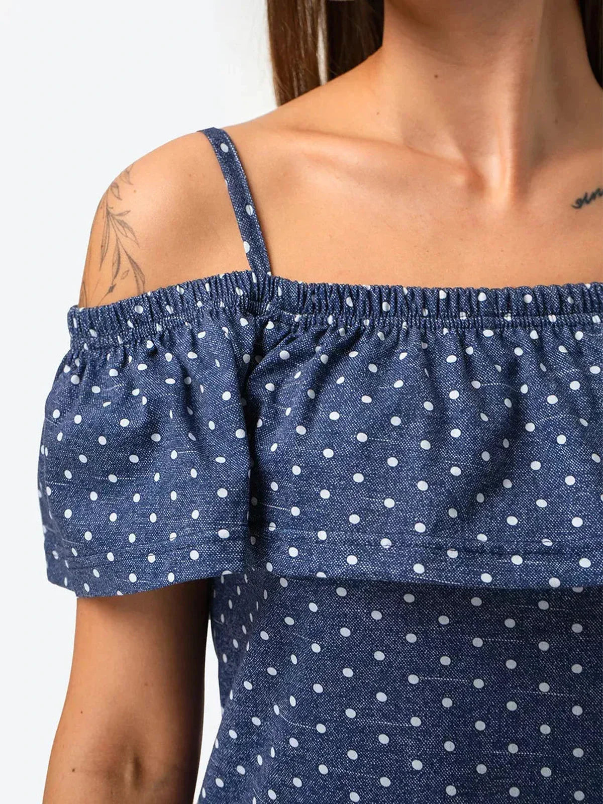 Close-up of the off-shoulder design detailing on the Scarlett Mini Dress by Lauven, showcasing blue polka dot cotton fabric.