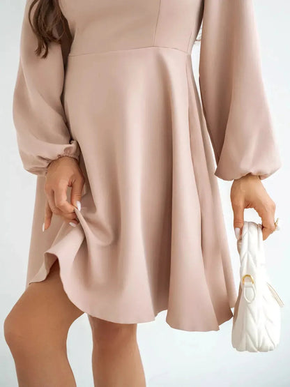 Milanese Mini Dress by Lauven in blush pink, showcasing long sleeves and flowing A-line silhouette.