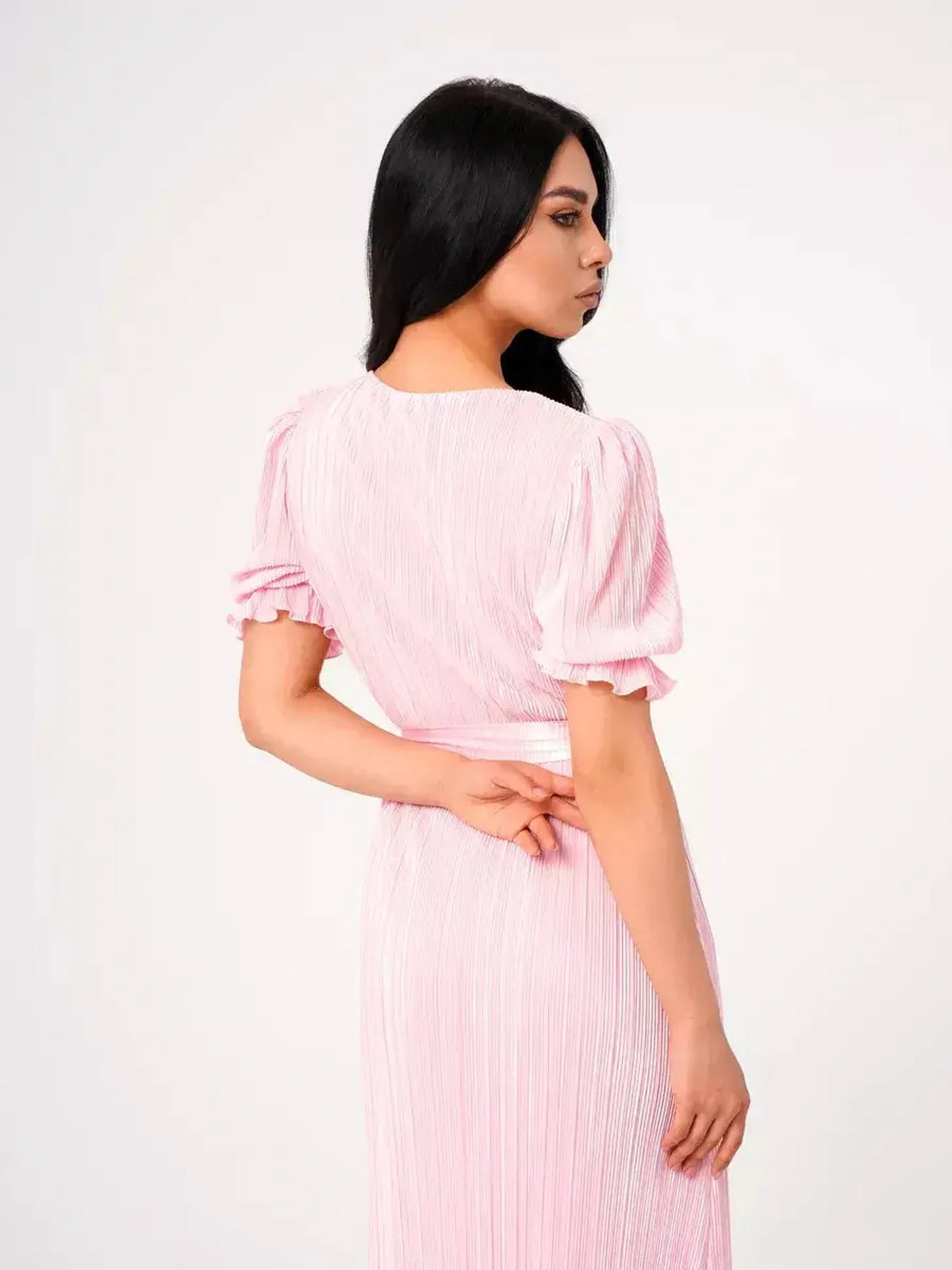 Candy Maxi Dress - Back view showcasing pleated elegance, puff sleeves, and a tie waist in soft pink fabric.