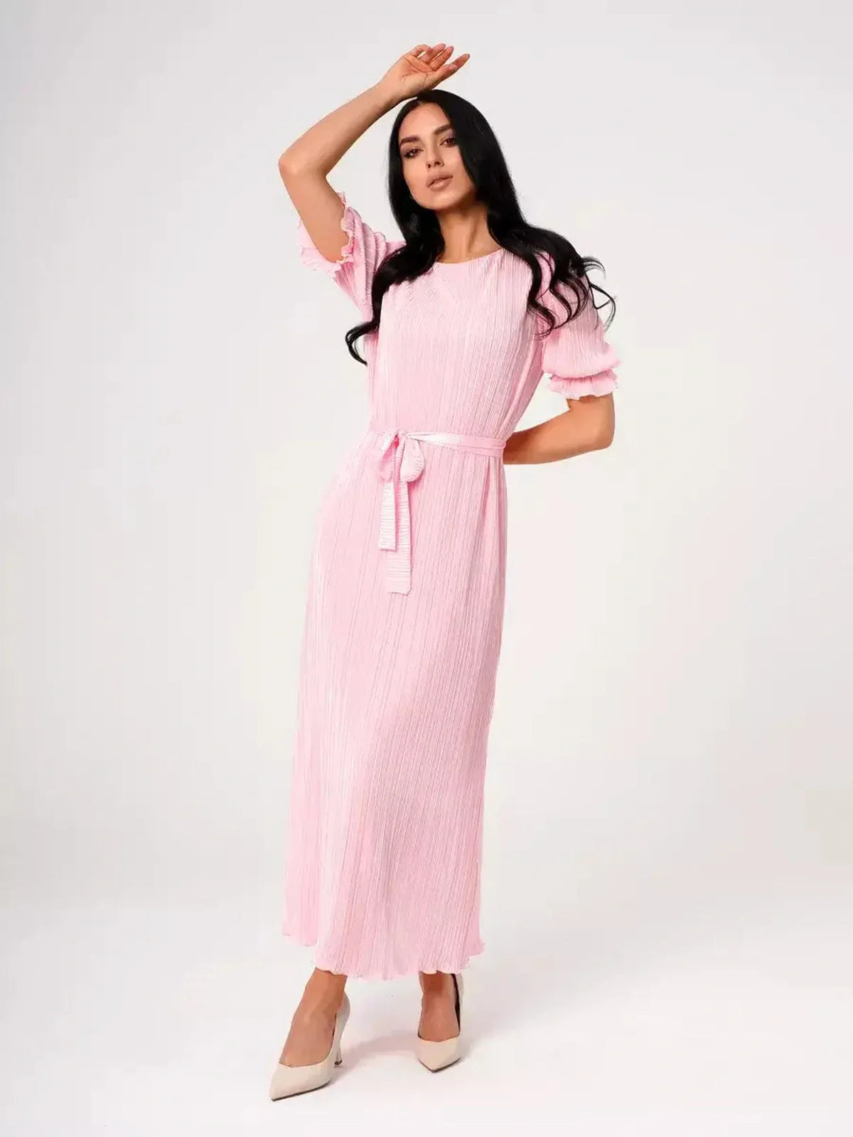 Candy Maxi Dress in pink with pleated fabric, puff sleeves, and a tie waist, embodying elegance and femininity.