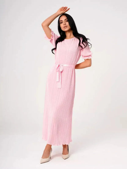 Candy Maxi Dress in pink with pleated fabric, puff sleeves, and a tie waist, embodying elegance and femininity.