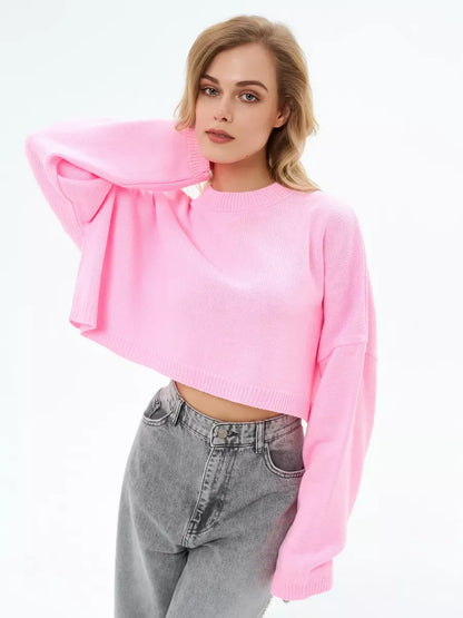 Model wearing a Candy Sweater in soft pink, featuring a cropped oversized knit design by Lauven.