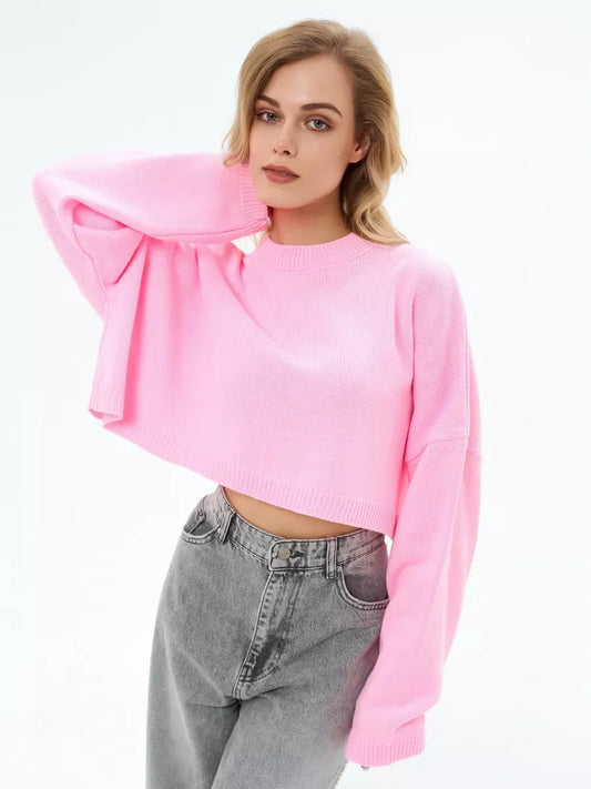 Model wearing a Candy Sweater in soft pink, featuring a cropped oversized knit design by Lauven.