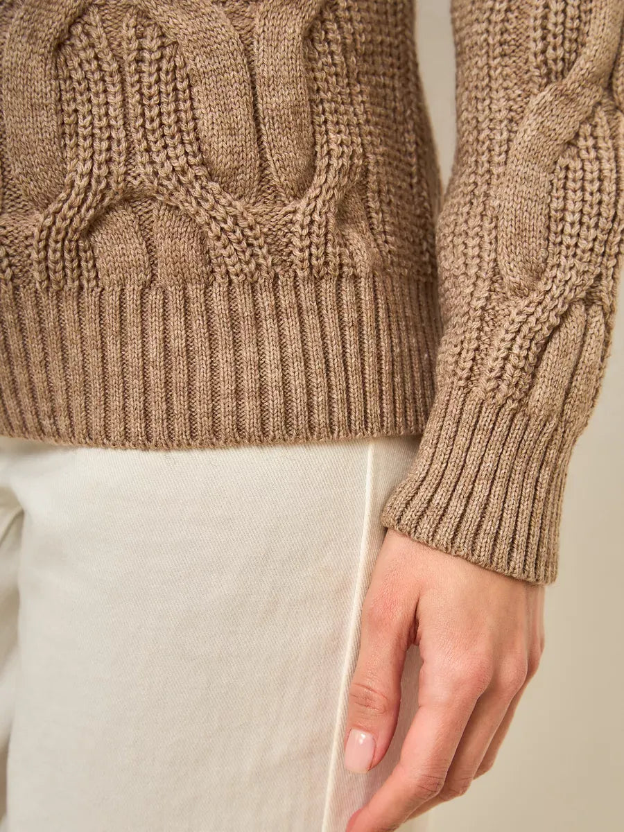 Close-up of the Cappuccino Knitwear, an oversized wool-blend turtleneck sweater by Lauven, showcasing intricate cable knit design.