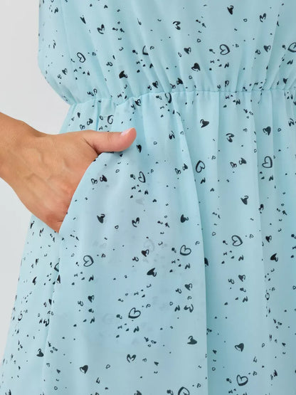 Celeste Mini Dress by Lauven showcasing a light blue fabric with heart prints and a pocket detail.