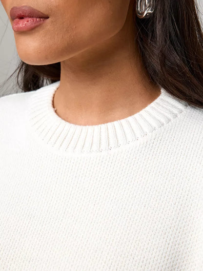 Close-up of woman wearing the Celeste Pullover from Lauven, featuring a soft ivory neckline for modern luxury.