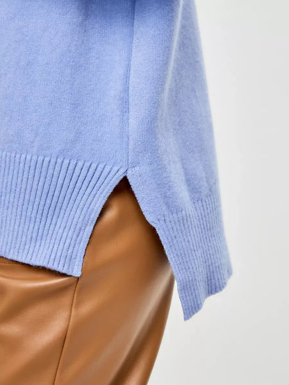 Side view of Celeste Sweater by Lauven, an oversized cashmere blend in soft blue with high ribbed hem.