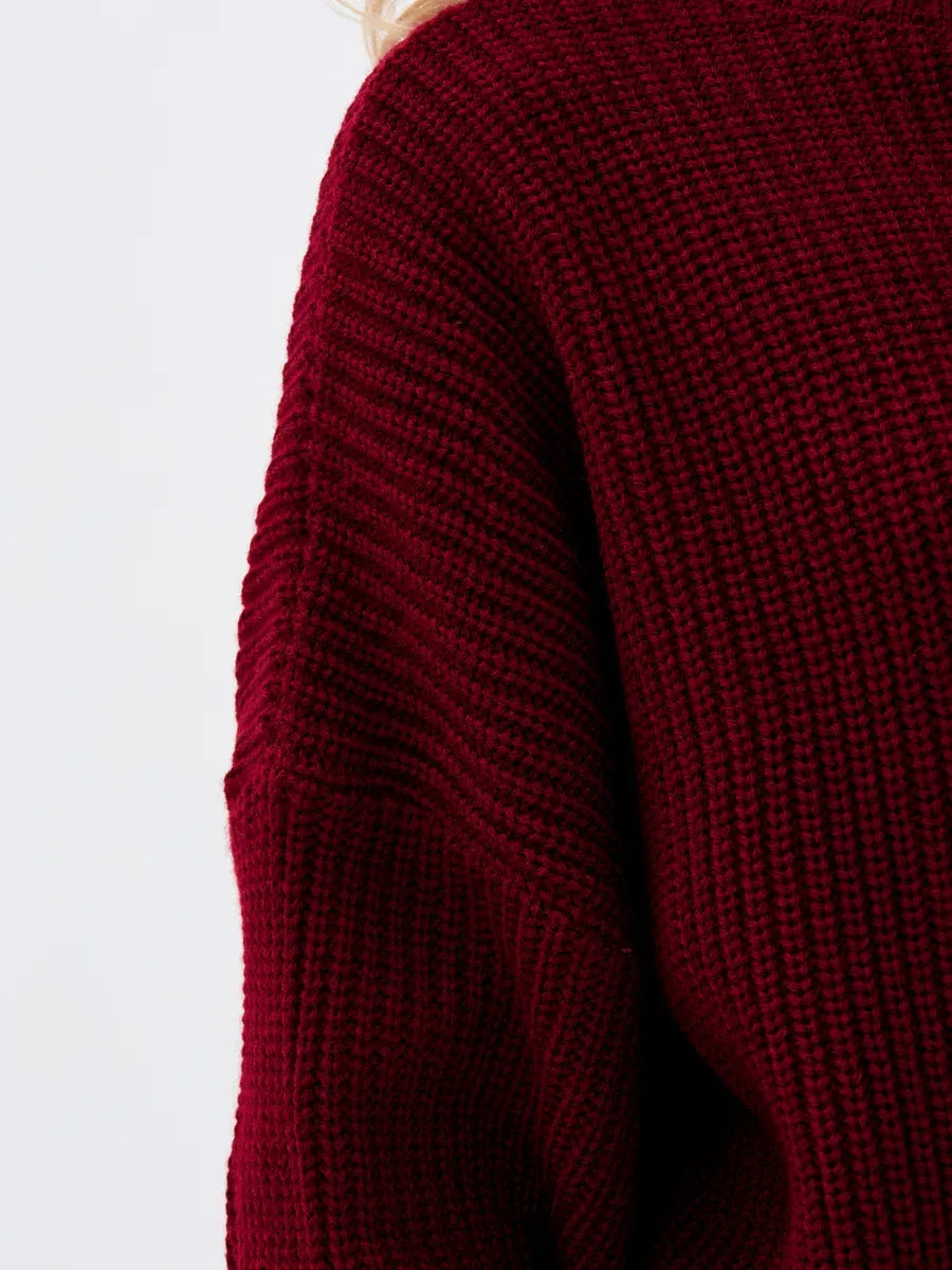 Close-up of a Crimson Pullover by Lauven, featuring a textured burgundy knit design and oversized fit.