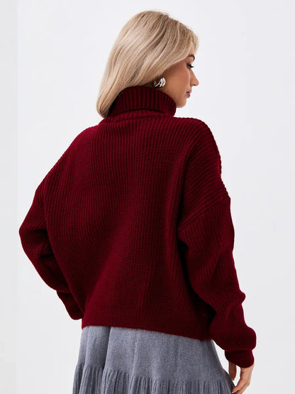 Back view of a woman wearing a Crimson Pullover by Lauven, oversized burgundy knit sweater with high neck.