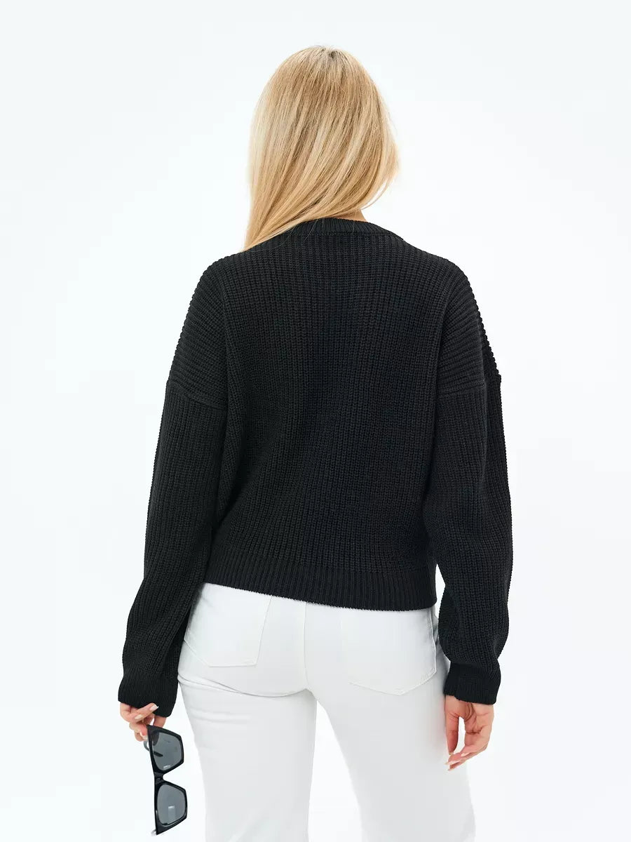 Back view of a woman wearing the Eclipse Sweater by Lauven in classic black with relaxed fit.