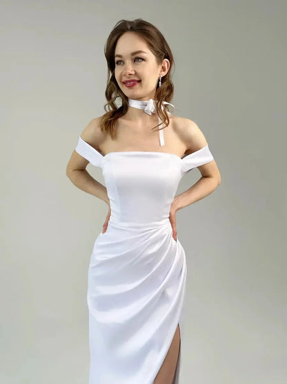 Eira Occasion Dress by Lauven - Elegant white satin off-shoulder gown with draping and high leg slit.