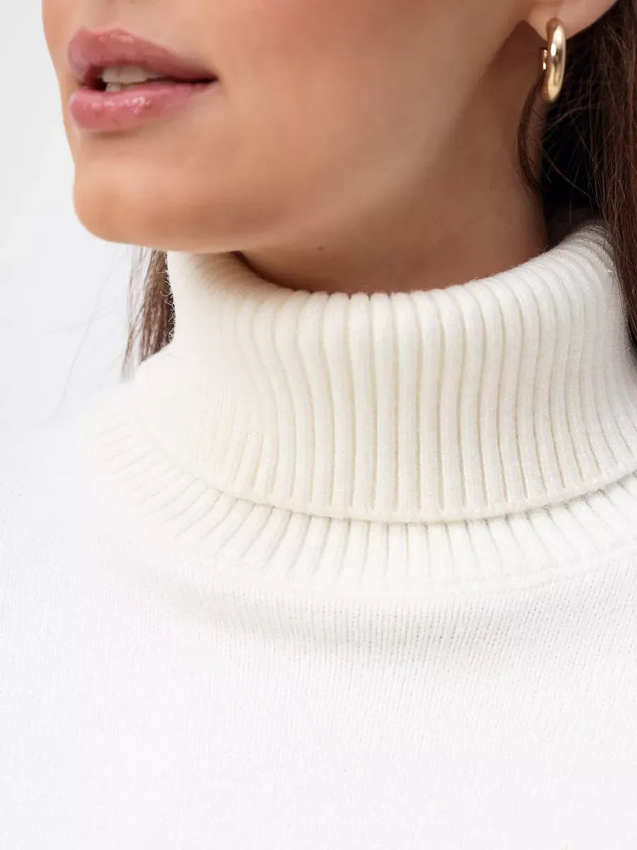 Close-up of a model wearing the Elara Sweater by Lauven, featuring a soft milk white turtleneck design.