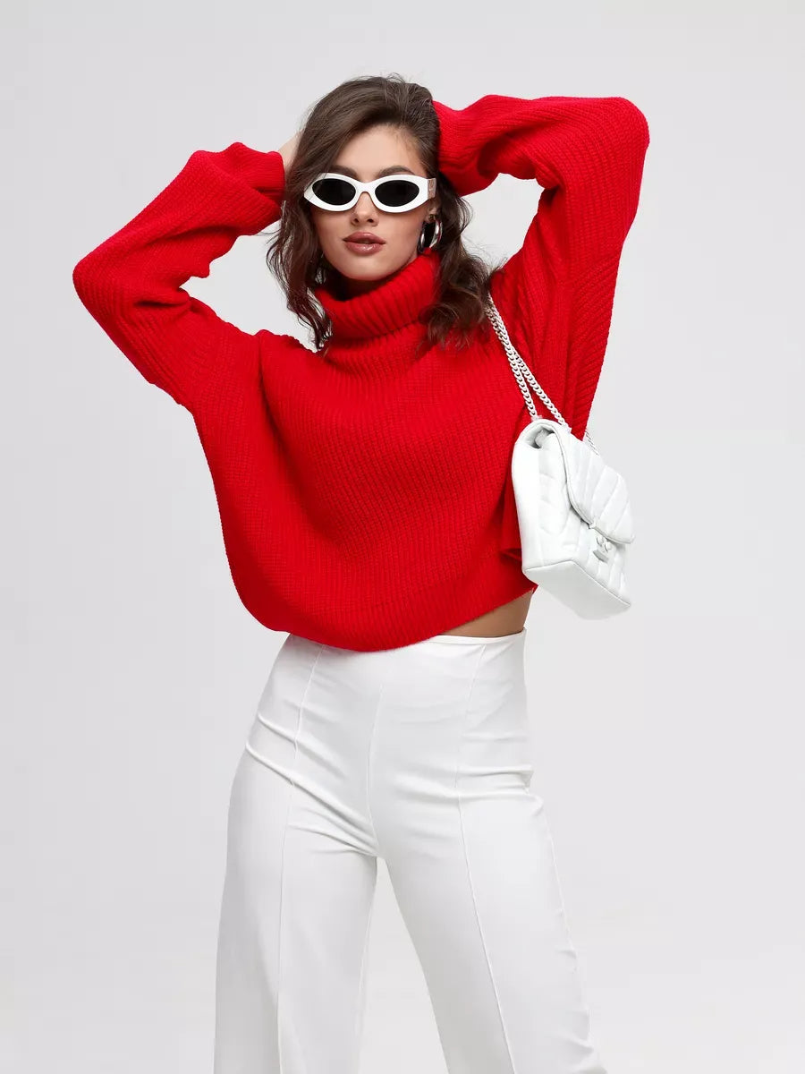 Ember Pullover by Lauven — Oversized knit sweater with high neck, red color, styled with white pants and sunglasses.