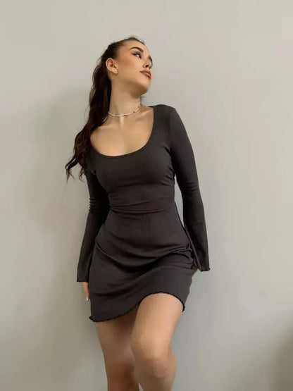 Emily Mini Dress by Lauven in black ribbed knit with long sleeves and flared cuffs, showcasing a square neckline.