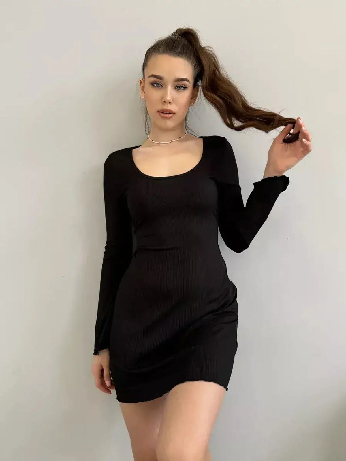 Emily Mini Dress by Lauven, black ribbed knit long sleeve mini dress with square neckline and flared cuffs.