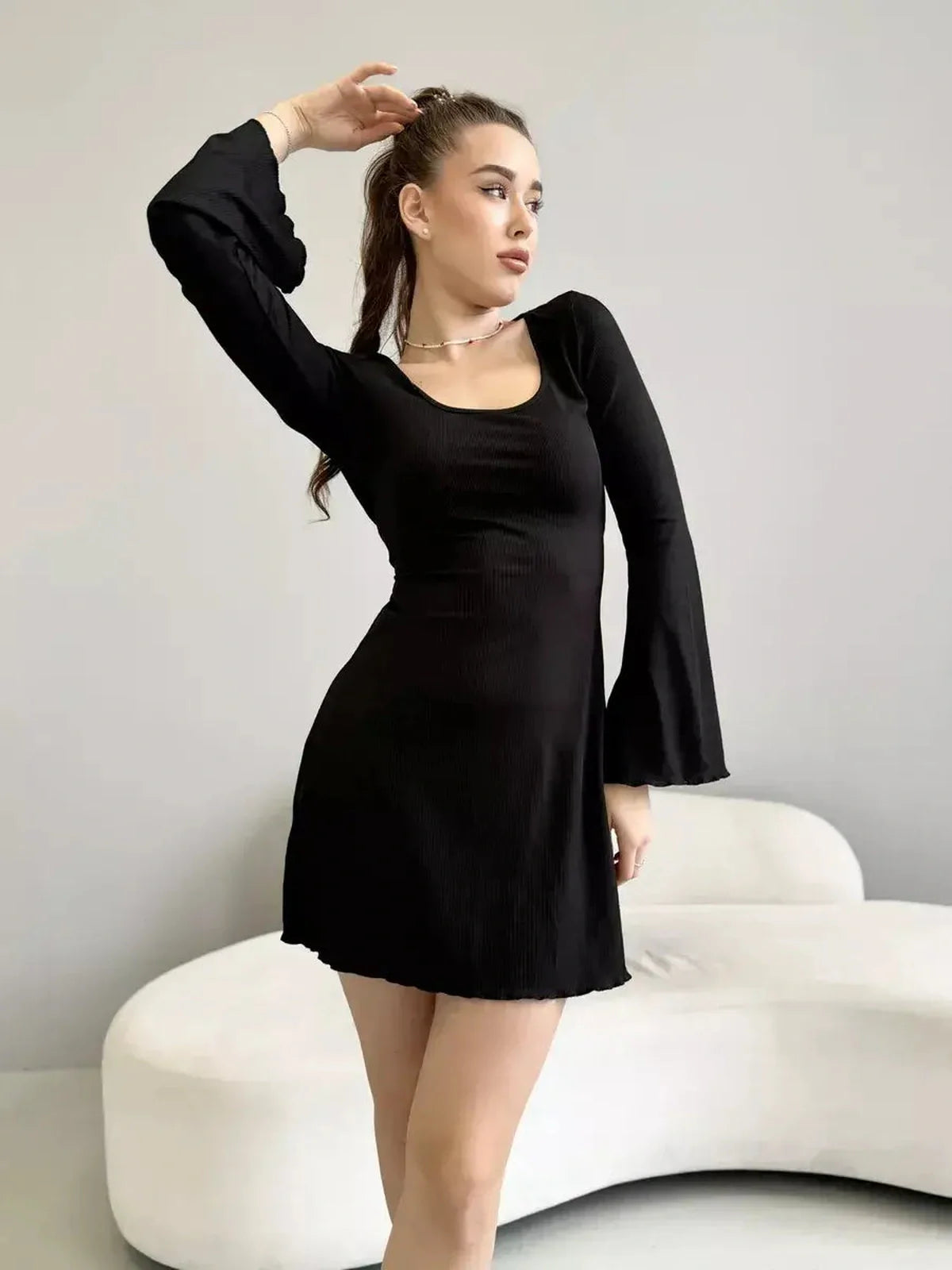 Emily Mini Dress by Lauven, black ribbed knit, long sleeve with square neckline and flared cuffs.