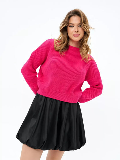 Flamingo Sweater by Lauven in bold fuchsia, oversized knit paired with a black skirt for a chic look.