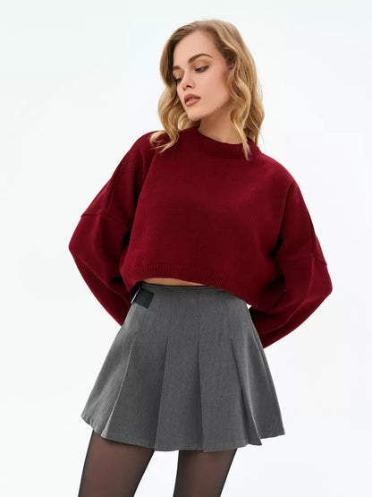 Garnet Sweater by Lauven, cropped oversized knit in deep burgundy style with a grey skirt.