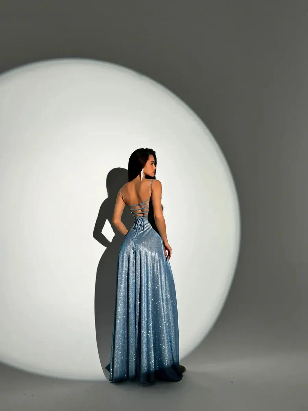 Glow Maxi Dress by Lauven, light blue glitter evening gown with adjustable fit, worn by model from behind.