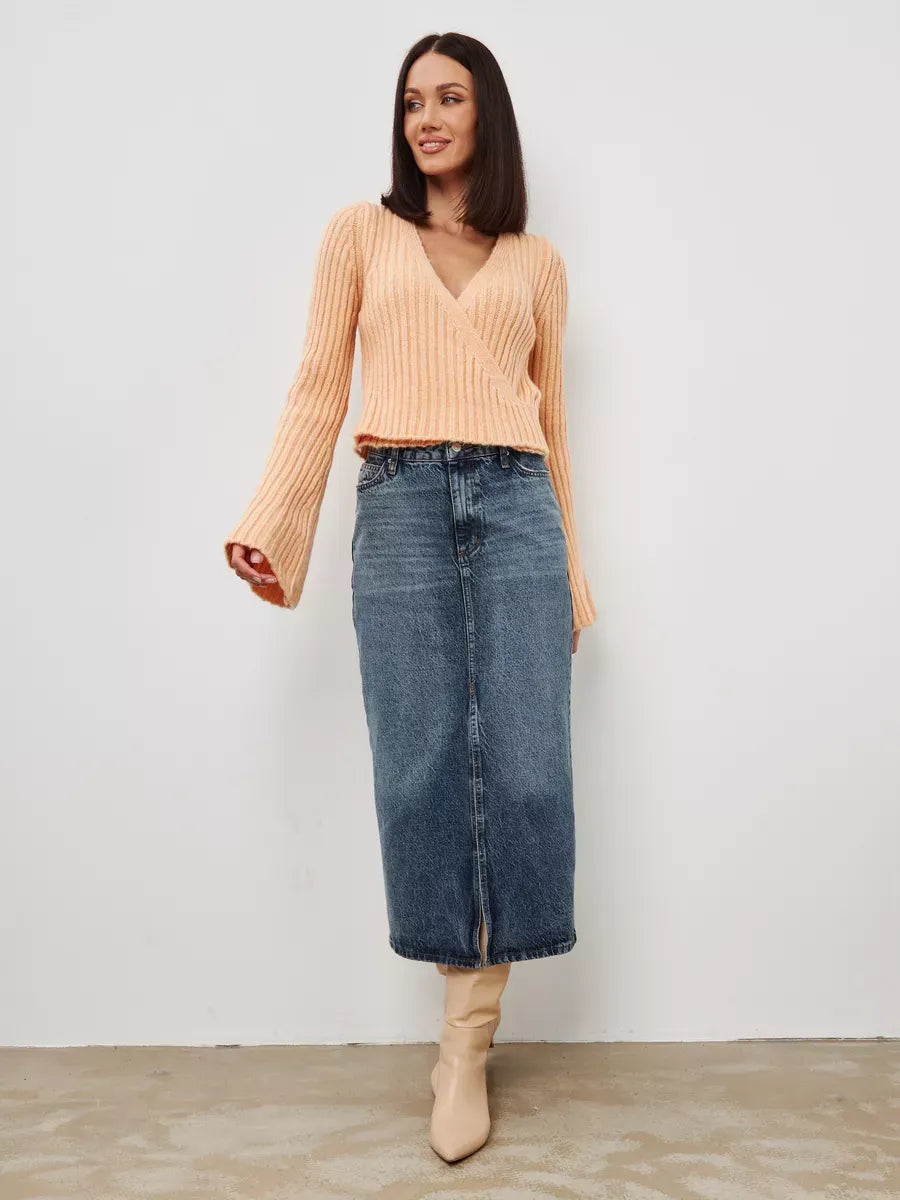 Aurelia Sweater by Lauven, cropped powder knit with V-neck and wide sleeves, styled with a denim skirt.