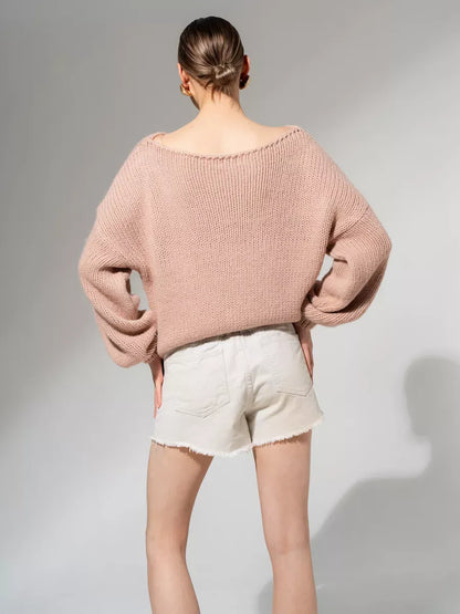 Lauven Rosea Sweater in powder pink, oversized off-shoulder knit, paired with white shorts.
