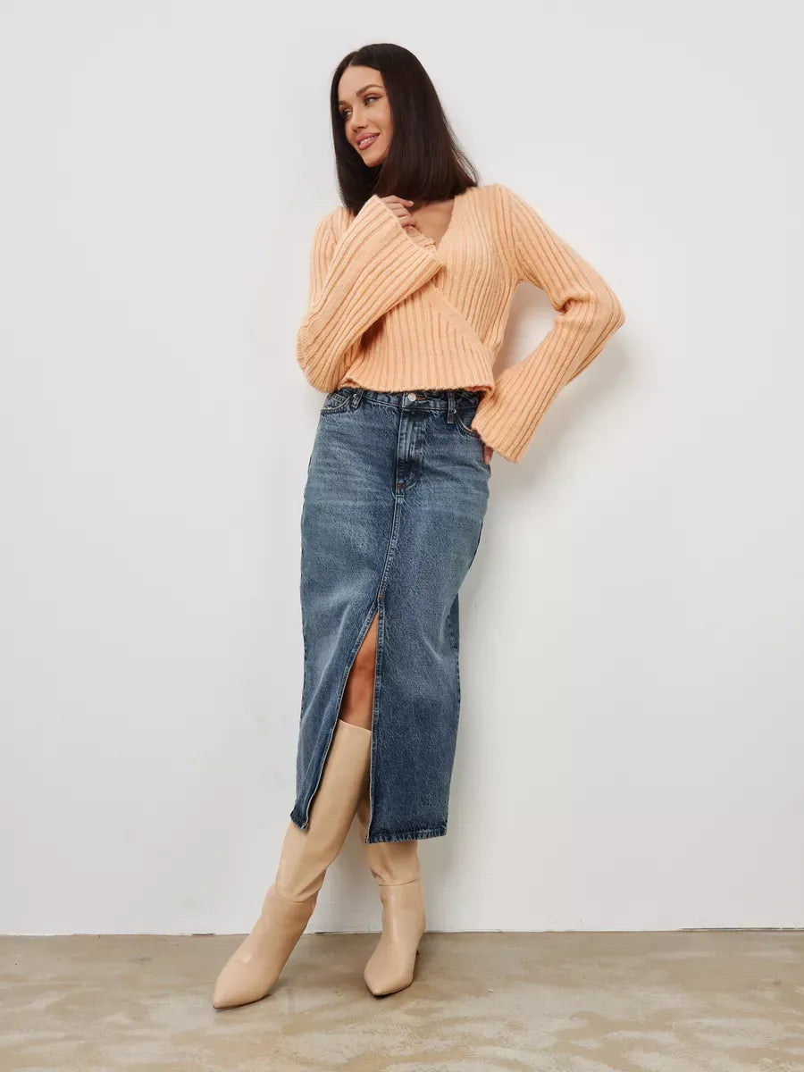 Aurelia Sweater by Lauven, cropped powder knit with V-neck, styled with a denim skirt and knee-high boots.