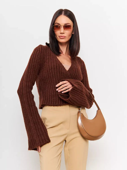 Model wearing Lauven Orion Sweater in brown knit, cropped with V-neck and wide sleeves, paired with stylish accessories.