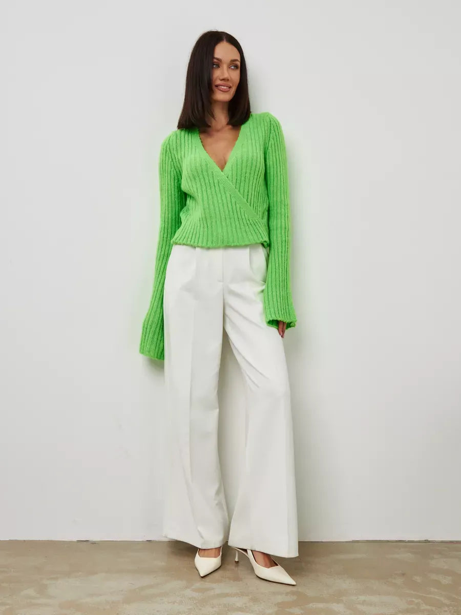 Vega Sweater by Lauven in cropped pistachio knit with V-neck and wide sleeves, styled with white trousers.